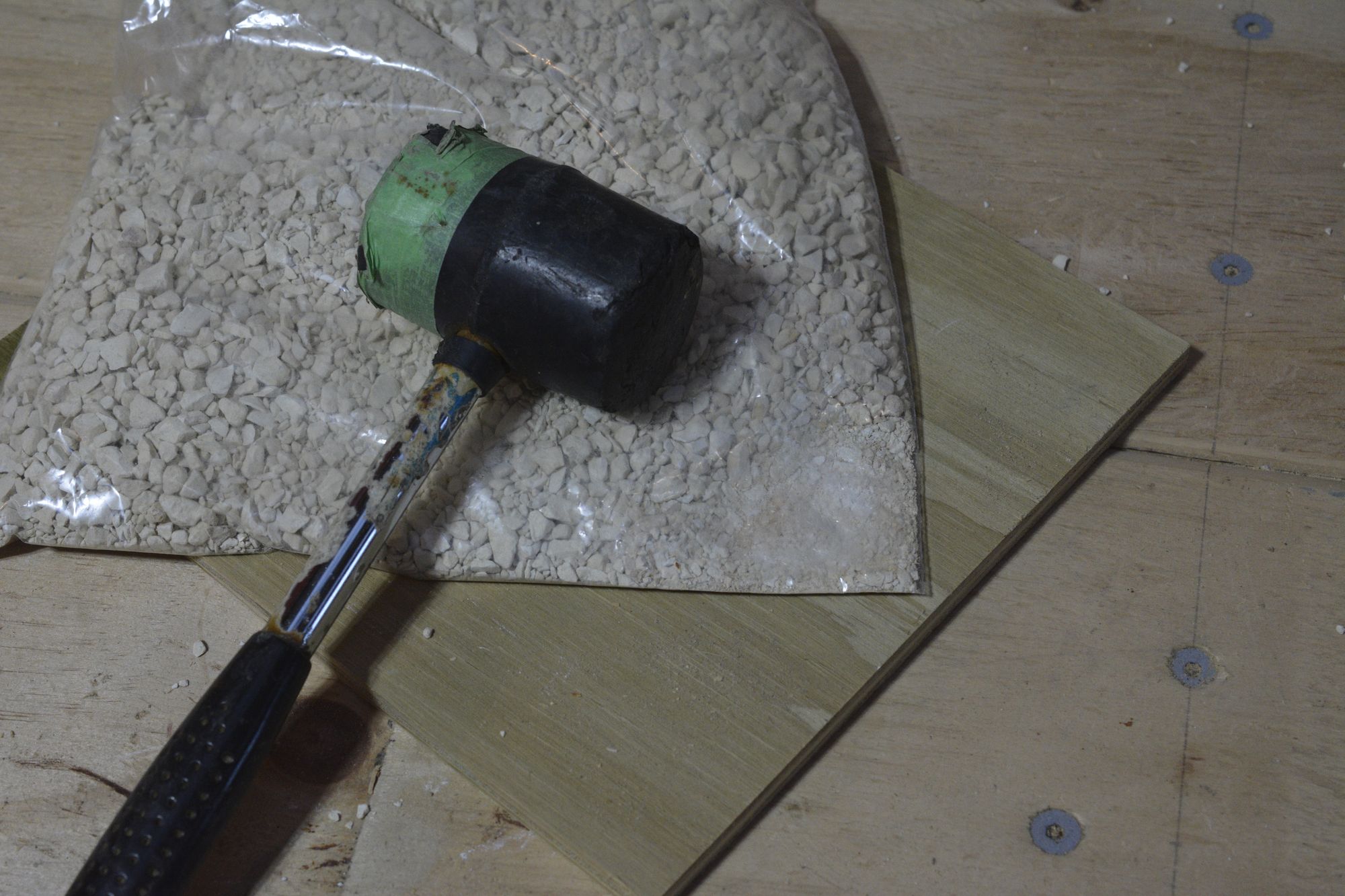 Crushing Bentonite Clay Cat Litter To A Fine Powder Using A Rubber Mallet